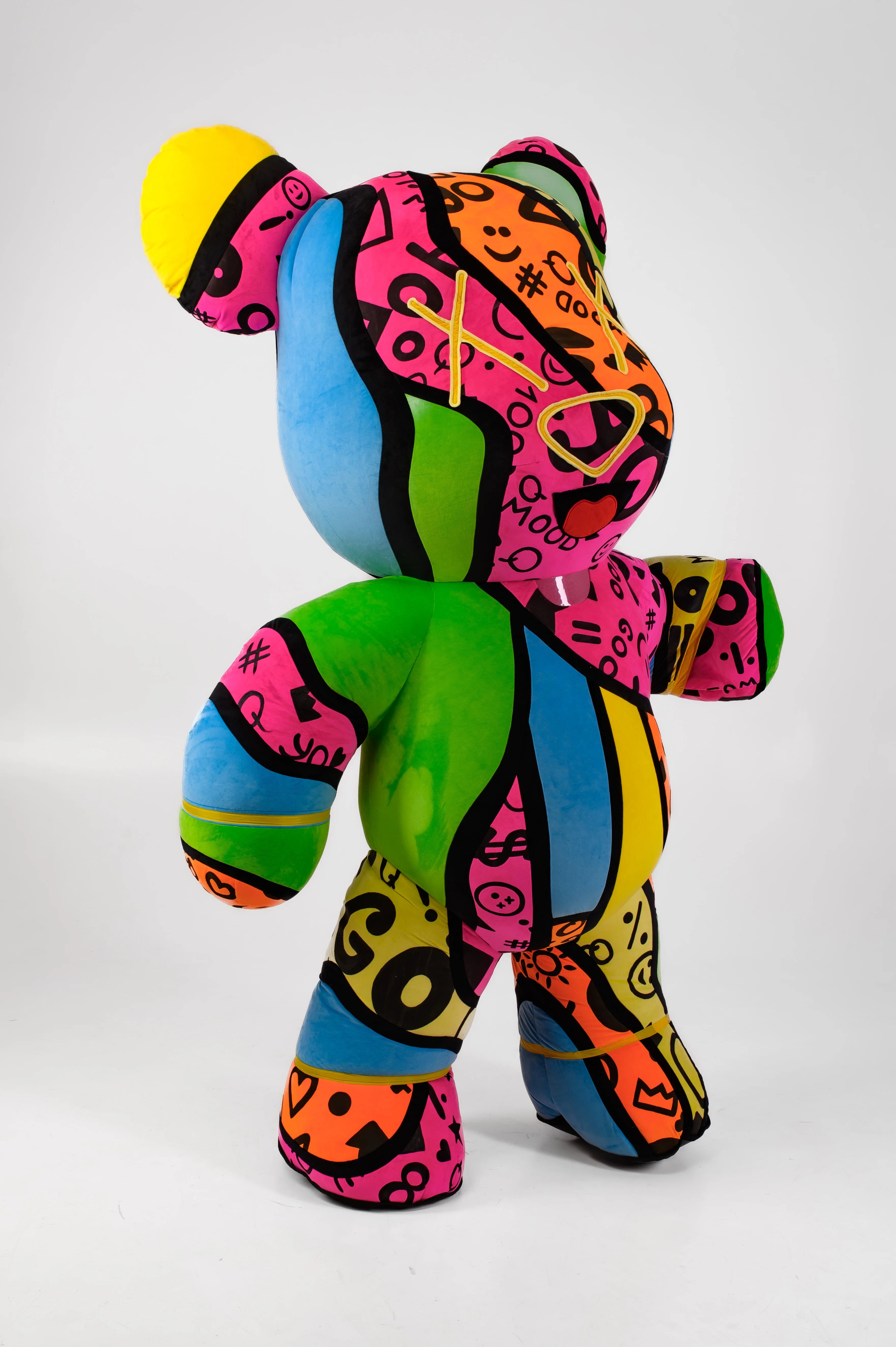 Colorful teddy bear with abstract patterns on a white background