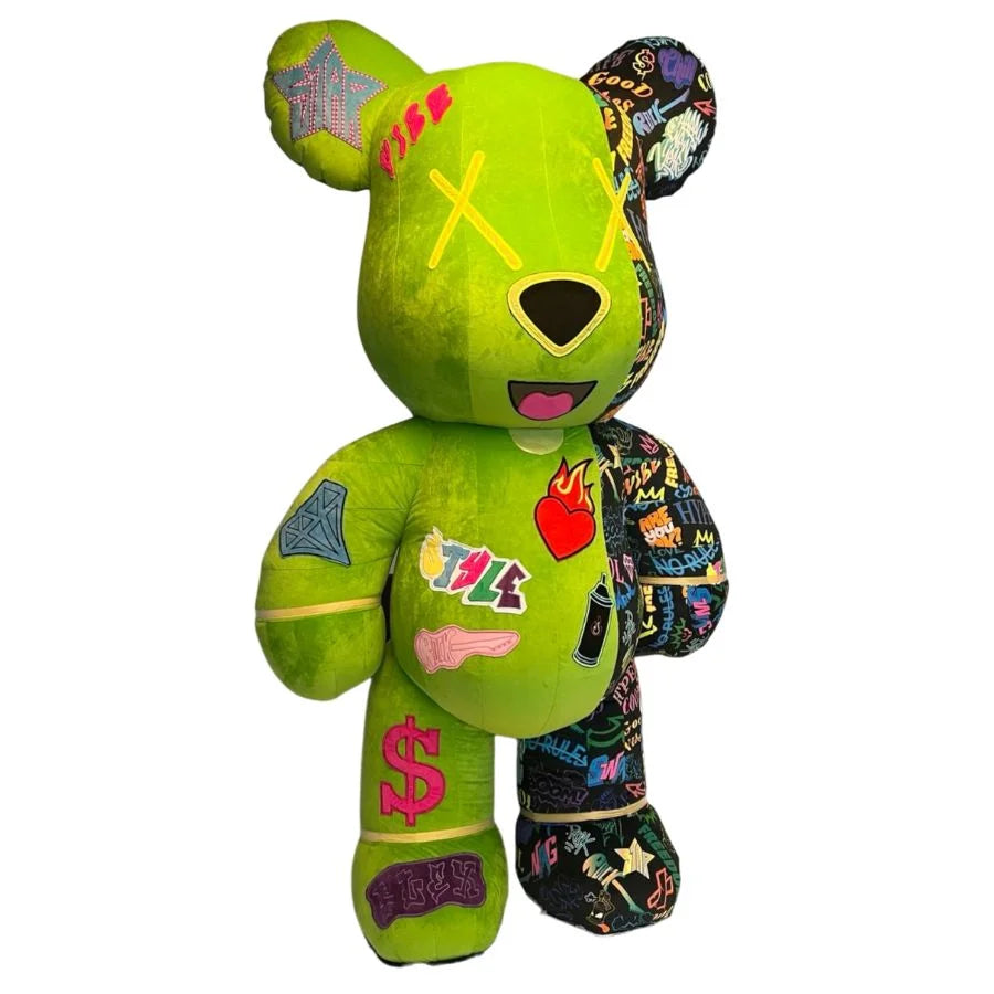 Green teddy bear with colorful patches and designs on a white background