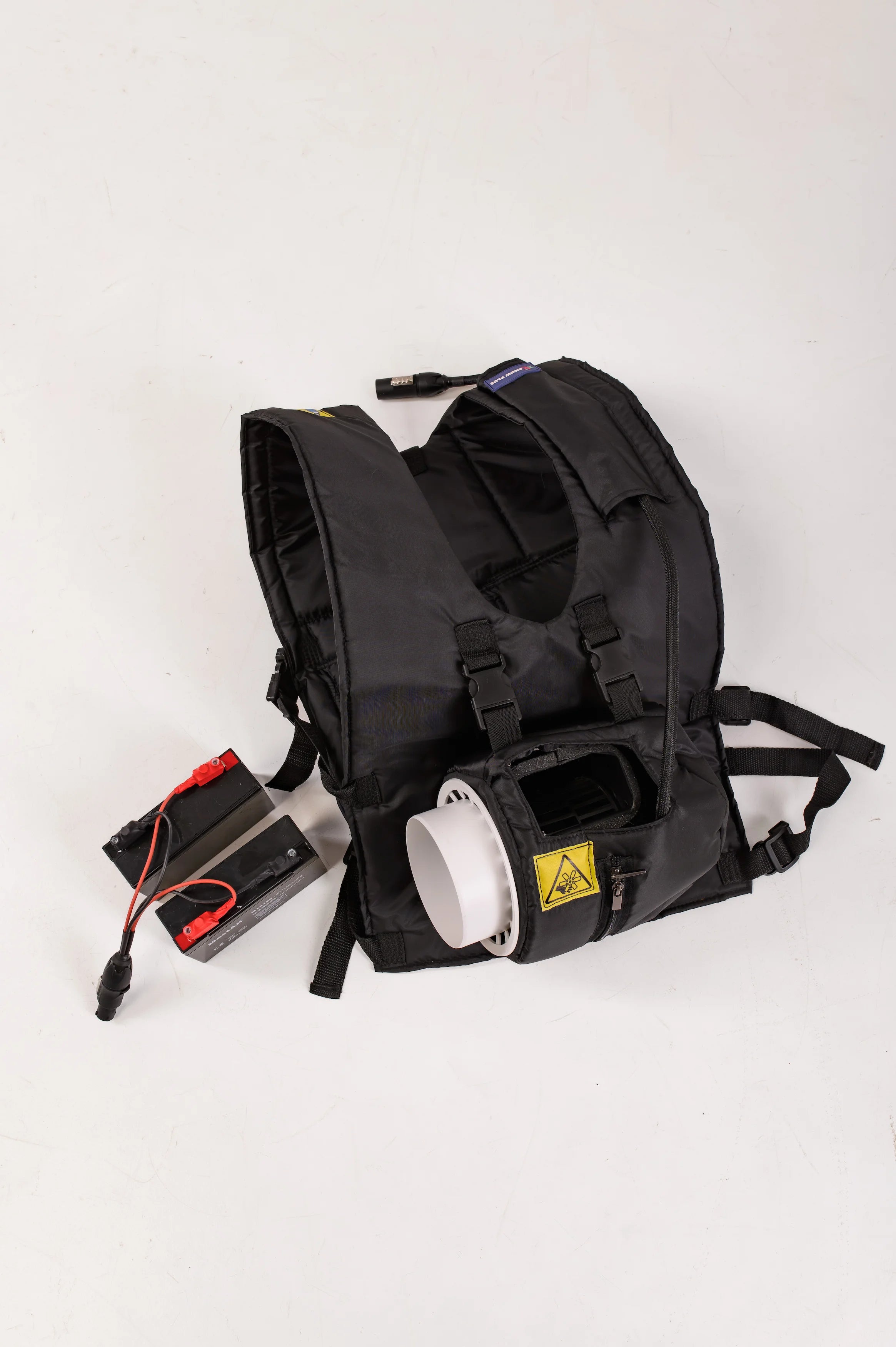 Black backpack with a battery and white container on a white background